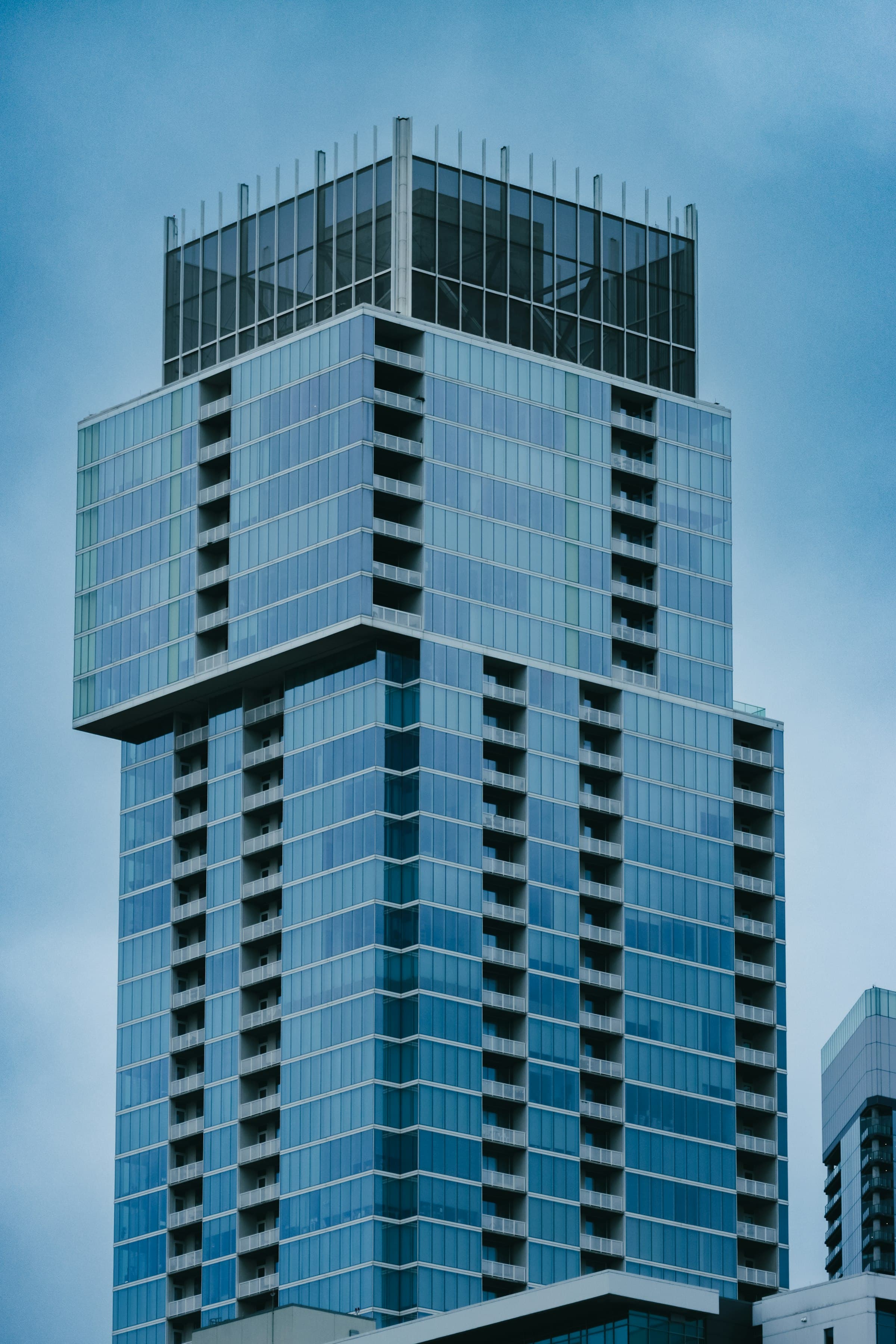Blue-glass crown of a modern luxury tower